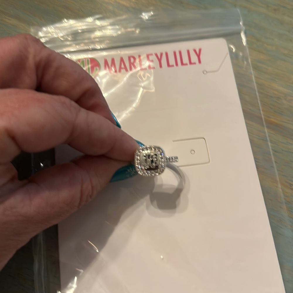 Silver size 9 ring with the initials AHL engraved on the face.